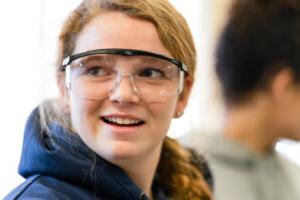 An inspired Trinity college student wearing safety goggles